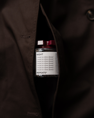 A small cylindrical bottle with a white label reading 